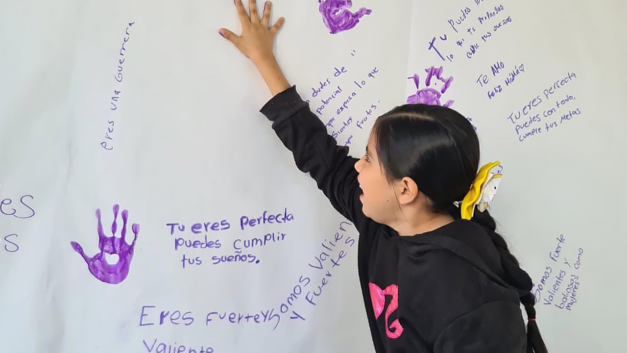 Estudiantes frente a un mural dedicado a la paz
